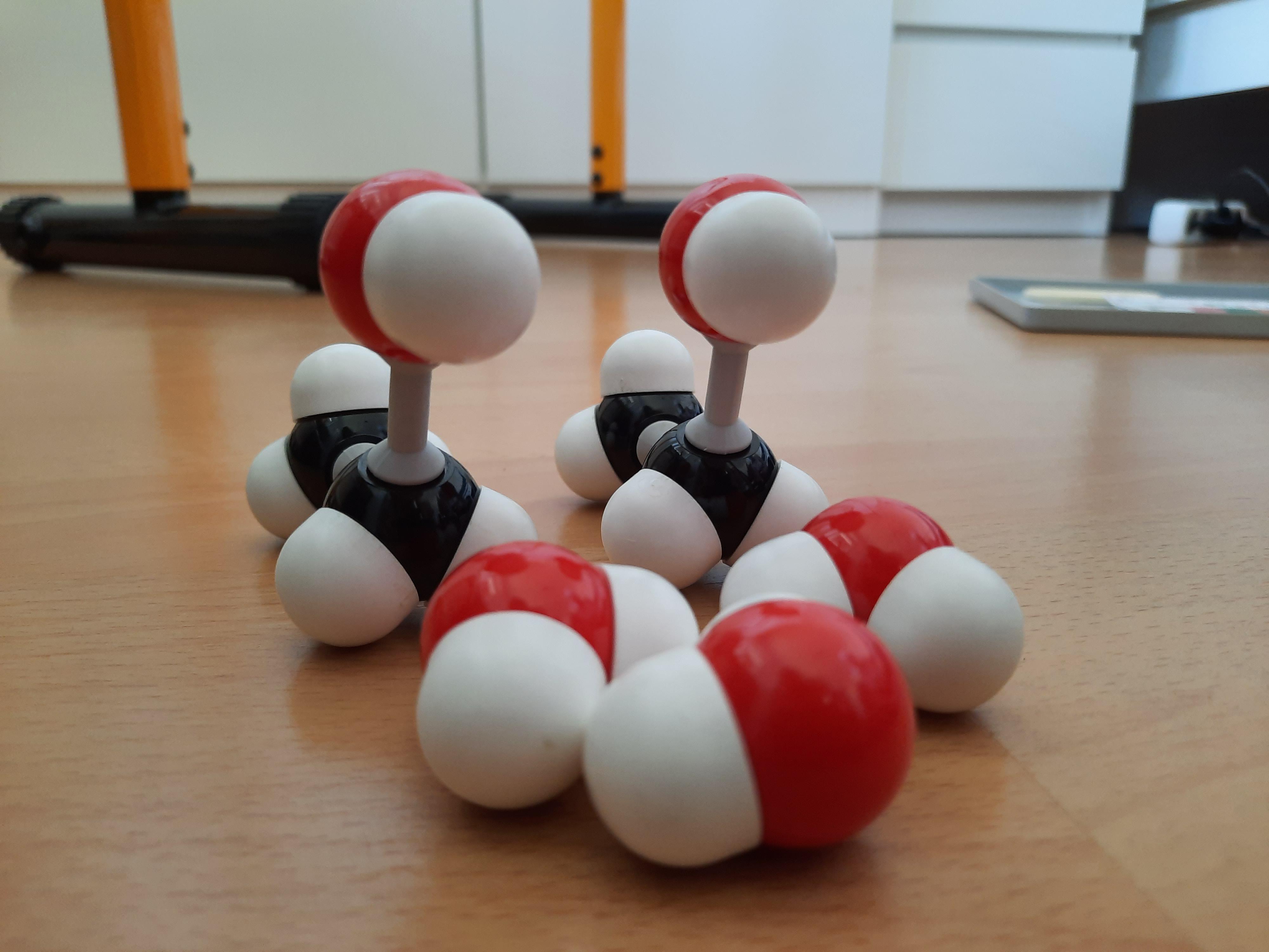 Two Carbon Doggos Babysitting Water Molecules